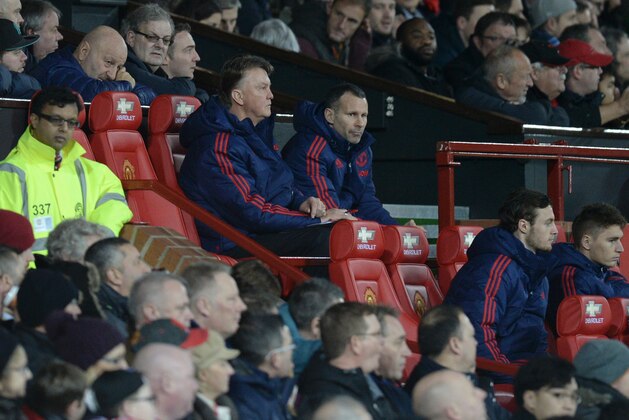 Manchester United's Dutch manager Louis van Gaal (CL) and Manchester United's Welsh assistant manager Ryan Giggs (CR) sit in the dugout during the English FA Cup third-round football match between Manchester United and Sheffield United at Old Trafford in north west England on January 9, 2016.   AFP PHOTO / OLI SCARFF

RESTRICTED TO EDITORIAL USE. No use with unauthorized audio, video, data, fixture lists, club/league logos or 'live' services. Online in-match use limited to 75 images, no video emulation. No use in betting, games or single club/league/player publications. / AFP / OLI SCARFF        (Photo credit should read OLI SCARFF/AFP/Getty Images)