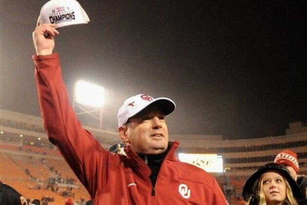 FILE - In this Nov. 28, 2015, file photo, Oklahoma head coach Bob Stoops holds up a Big 12 Champions hat following a 58-23 win over Oklahoma State in an NCAA college football game in Stillwater, Okla. The Sooners wisely stuck with Stoops as their head coach, even when many in this what-have-you-done-for-me-lately world questioned whether he was the guy to lead them back to the promised land. Now, the Sooners are Big 12 Conference champions and two wins away from a national championship. (AP Photo/Brody Schmidt, File)