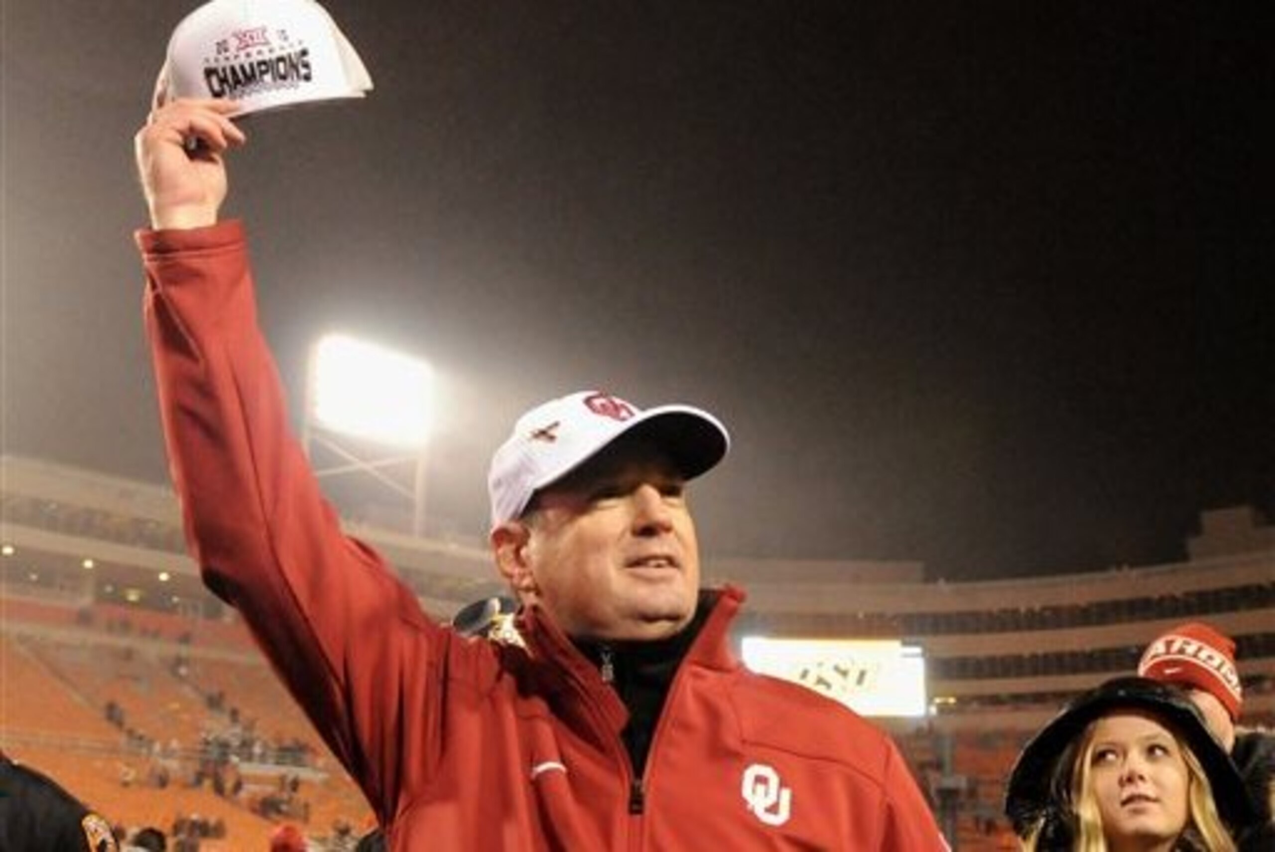 FILE - In this Nov. 28, 2015, file photo, Oklahoma head coach Bob Stoops holds up a Big 12 Champions hat following a 58-23 win over Oklahoma State in an NCAA college football game in Stillwater, Okla. The Sooners wisely stuck with Stoops as their head coach, even when many in this what-have-you-done-for-me-lately world questioned whether he was the guy to lead them back to the promised land. Now, the Sooners are Big 12 Conference champions and two wins away from a national championship. (AP Photo/Brody Schmidt, File)