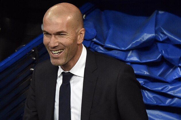 Real Madrid's new French coach Zinedine Zidane smiles as he arrives at the pitch before the Spanish league football match Real Madrid CF vs RC Deportivo La Coruna at the Santiago Bernabeu stadium in Madrid on January 9, 2016.  AFP PHOTO / GERARD JULIEN / AFP / GERARD JULIEN        (Photo credit should read GERARD JULIEN/AFP/Getty Images)