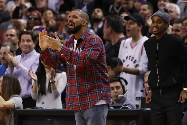 TORONTO, ON - NOVEMBER 25:  Singer Drake celebrates a Raptors score on 'Drake Night' during an NBA game between the Cleveland Cavaliers and the Toronto Raptors at the Air Canada Centre on November 25, 2015 in Toronto, Ontario, Canada.  NOTE TO USER: User expressly acknowledges and agrees that, by downloading and or using this photograph, User is consenting to the terms and conditions of the Getty Images License Agreement.  (Photo by Vaughn Ridley/Getty Images)