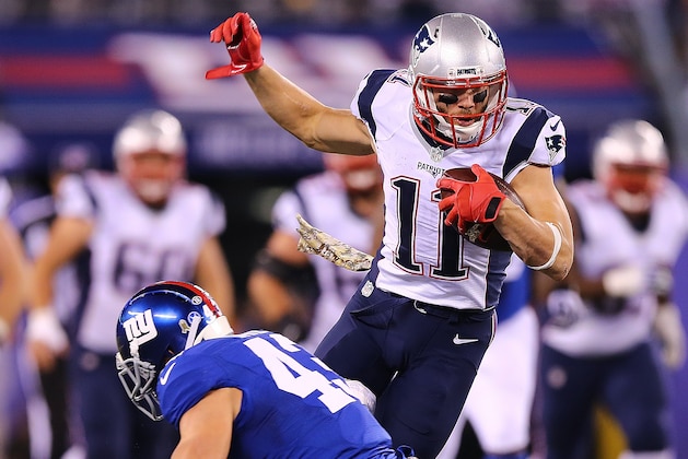 EAST RUTHERFORD, NJ - NOVEMBER 15:  Julian Edelman #11 of the New England Patriots avoids the tackle of Craig Dahl #43 of the New York Giants during the first quarter at MetLife Stadium on November 15, 2015 in East Rutherford, New Jersey.  (Photo by Elsa/Getty Images)