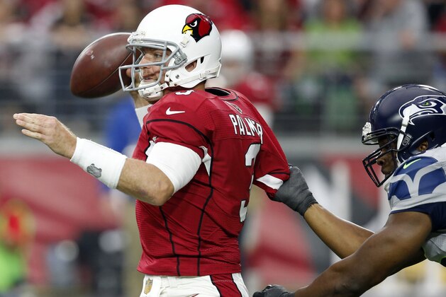 Arizona Cardinals quarterback Carson Palmer (3) is pressured by Seattle Seahawks defensive end Cliff Avril during the first half of an NFL football game, Sunday, Jan. 3, 2016, in Glendale, Ariz. (AP Photo/Ross D. Franklin)