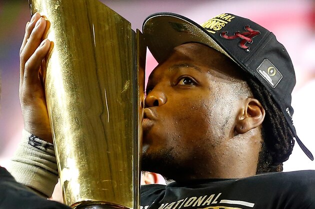 GLENDALE, AZ - JANUARY 11:  Derrick Henry #2 of the Alabama Crimson Tide celebrates by kissing the College Football Playoff National Championship Trophy after defeating the Clemson Tigers in the 2016 College Football Playoff National Championship Game at University of Phoenix Stadium on January 11, 2016 in Glendale, Arizona.  The Crimson Tide defeated the Tigers with a score of 45 to 40.  (Photo by Christian Petersen/Getty Images)