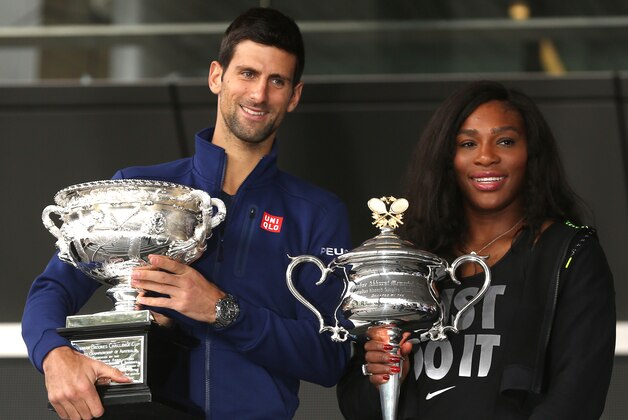 Defending champions Serena Williams of the US and Serbia's Novak Djokovic pose for a photo with their trophies as they arrive for the official draw at the Australian Open tennis championships in Melbourne, Australia, Friday, Jan. 15, 2016. (AP Photo/Mark Baker)