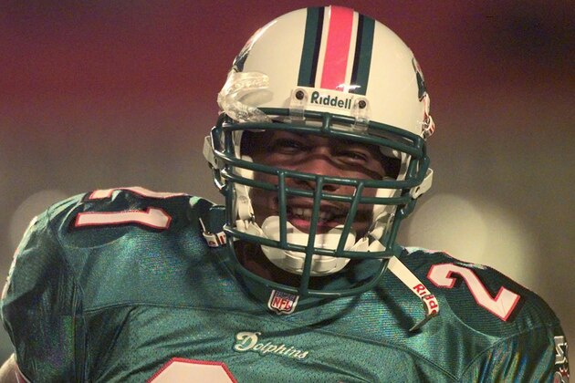 Lawerence Phillips smiles as the crowd in the stands at Pro Player Stadium calls out to him as he takes the field for the first time in a Miami Dolphins uniform Sunday Dec. 7, 1997 in Miami before a game against the Detroit Lions. Phillips signed with the Dolphins last week after a stormy stint with the Saint Louis Rams.(AP Photo/Joe Cavaretta) Lawerence Phillips smiles as the crowd in the stands at Pro Player Stadium calls out to him as he takes the field for the first time in a Miami Dolphins uniform Sunday Dec. 7, 1997 in Miami before a game against the Detroit Lions. Phillips signed with the Dolphins last week after a stormy stint with the Saint Louis Rams.(AP Photo/Joe Cavaretta)