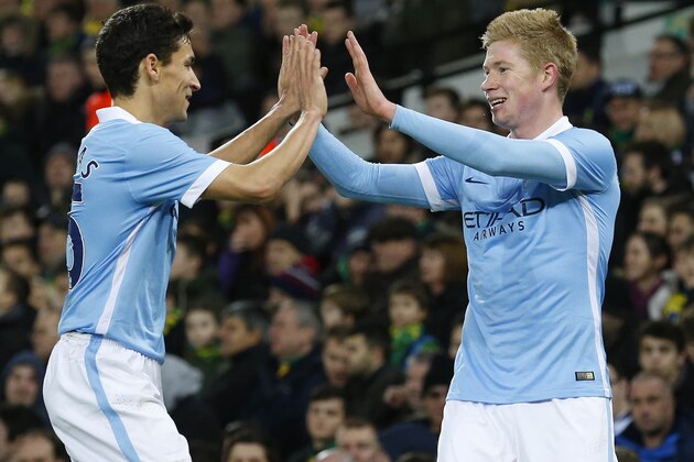 Manchester City's Belgian midfielder Kevin De Bruyne (R) celebrates scoring his team's third goal during the FA Cup third-round football match between Norwich City and Manchester City at Carrow Road in Norwich, eastern England on January 9, 2016.   AFP PHOTO / LINDSEY PARNABYRESTRICTED TO EDITORIAL USE. No use with unauthorized audio, video, data, fixture lists, club/league logos or 'live' services. Online in-match use limited to 75 images, no video emulation. No use in betting, games or single club/league/player publications. / AFP / LINDSEY PARNABY        (Photo credit should read LINDSEY PARNABY/AFP/Getty Images)
