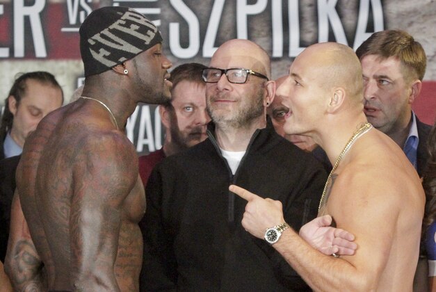 Undefeated WBC heavyweight world boxing champion Deontay Wilder, left, and Polish challenger Artur Szpilka are separated as they exchange words after their weigh-in at Barclays Center, Friday, Jan. 15, 2016, in Brooklyn, N.Y.  Wilder will make his third title defense,  against Szpilka,  on Saturday, Jan. 16, 2016, at  Barclays Center.  (AP Photo/Bebeto Matthews)
