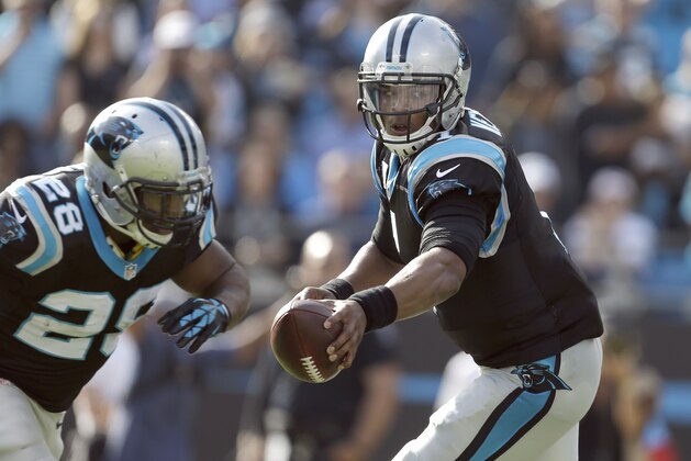 Carolina Panthers' Jonathan Stewart (28) makes a move towards the handoff as Carolina Panthers' Cam Newton (1) checks the Atlanta Falcons' defense before deciding to handoff or throw during the first half of an NFL football game in Charlotte, N.C., Sunday, Dec. 13, 2015. The Panthers won 38-0. (AP Photo/Bob Leverone)
