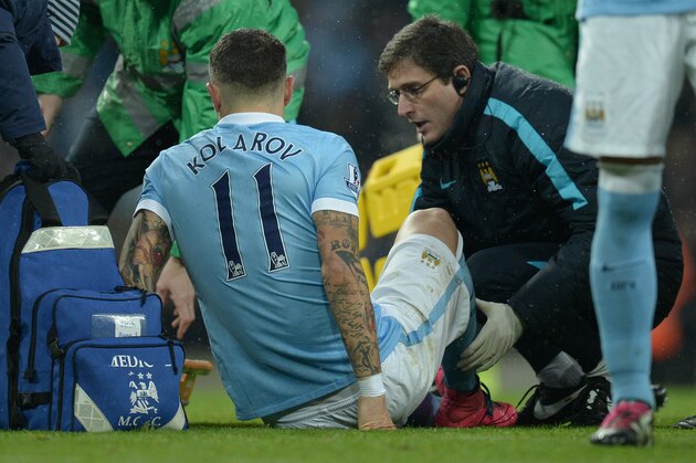 Manchester City's Serbian defender Aleksandar Kolarov (L) receives medical treatment before being taken off of the pitch on a stretcher during the English Premier League football match between Manchester City and Crystal Palace at the Etihad Stadium in Manchester, north west England, on January 16, 2016. AFP PHOTO / OLI SCARFF

RESTRICTED TO EDITORIAL USE. No use with unauthorized audio, video, data, fixture lists, club/league logos or 'live' services. Online in-match use limited to 75 images, no video emulation. No use in betting, games or single club/league/player publications. / AFP / OLI SCARFF        (Photo credit should read OLI SCARFF/AFP/Getty Images)