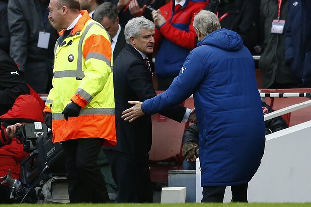 LONDON, ENGLAND - JANUARY 11:  Arsene Wenger, manager of Arsenal shakes hands with Mark Hughes, manager of Stoke City after the Barclays Premier League match between Arsenal and Stoke City at Emirates Stadium on January 11, 2015 in London, England.  (Photo by Julian Finney/Getty Images)