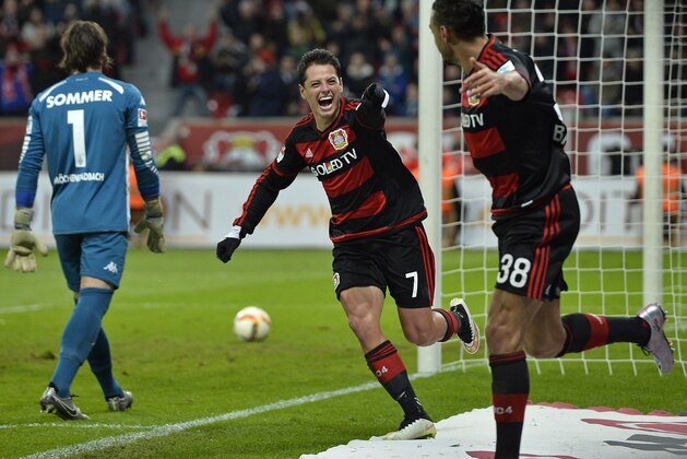 Leverkusen’s Javier Hernandez celebrates his third goal with teammate Karim Bellarabi, right, during the German Bundesliga soccer match between Bayer Leverkusen and Borussia Moenchengladbach in Leverkusen, Germany, Saturday, Dec. 12, 2015. Leverkusen defeated Moenchengladbach with 5-0, Hernandez scored three goals. (AP Photo/Martin Meissner)