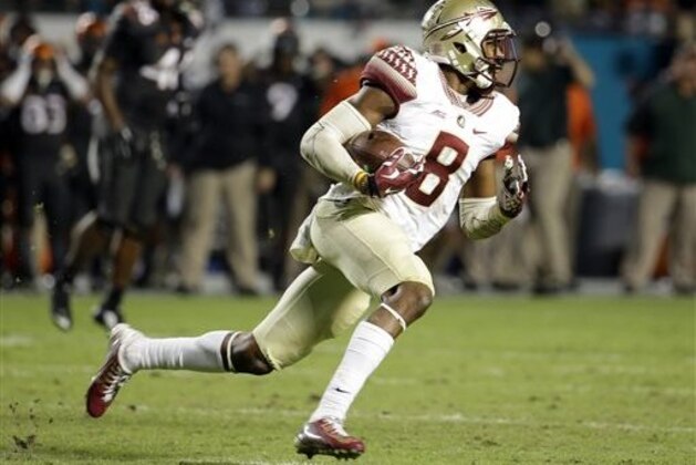 FILE - In this Nov. 15, 2014, file photo, Florida State defensive back Jalen Ramsey runs with the ball after intercepting a pass thrown by Miami  quarterback Brad Kaaya during the second half an NCAA college football game in Miami Gardens, Fla. Ramsey has already been a national champion and All-American. Eventually, he could be an All-Pro. In between, he would like to add gold medalist. Ramsey is also one of the best long jumpers in the country.(AP Photo/Lynne Sladky, File)