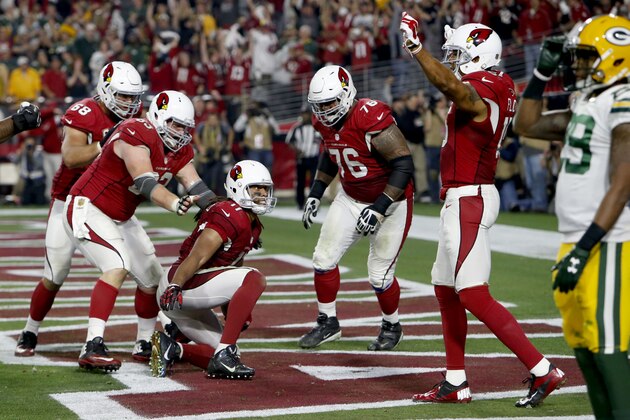 Arizona Cardinals wide receiver Larry Fitzgerald (11) celebrates his game winning touchdown with teammates agasint the Green Bay Packers during overtime of an NFL divisional playoff football game, Saturday, Jan. 16, 2016, in Glendale, Ariz. The Cardinals won 26-20 in overtime. (AP Photo/Rick Scuteri)