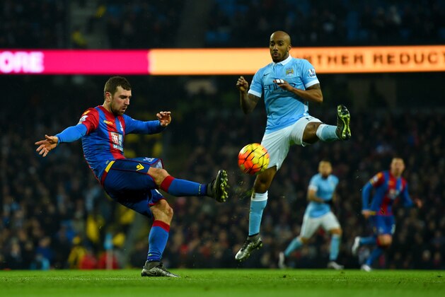 MANCHESTER, ENGLAND - JANUARY 16:  James McArthur of Crystal Palace clears the ball under pressure from Fabian Delph of Manchester City during the Barclays Premier League match between Manchester City and Crystal Palace at Etihad Stadium on January 16, 2016 in Manchester, England.  (Photo by Shaun Botterill/Getty Images)