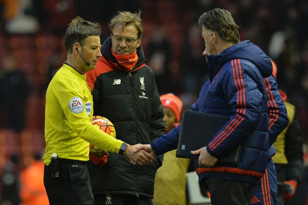 Manchester United's Welsh assistant manager Ryan Giggs (R obscured) shakes hands with referee Mark Clattenburg (L) as Manchester United's Dutch manager Louis van Gaal (R) and Liverpool's German manager Jurgen Klopp (2L) look on after the English Premier League football match between Liverpool and Manchester United at Anfield in Liverpool, northwest England, on January 17, 2016. Wayne Rooney scored the winning goal in Manchester United's 1-0 victory over Liverpool. AFP PHOTO / PAUL ELLIS

RESTRICTED TO EDITORIAL USE. No use with unauthorized audio, video, data, fixture lists, club/league logos or 'live' services. Online in-match use limited to 75 images, no video emulation. No use in betting, games or single club/league/player publications. / AFP / PAUL ELLIS        (Photo credit should read PAUL ELLIS/AFP/Getty Images)