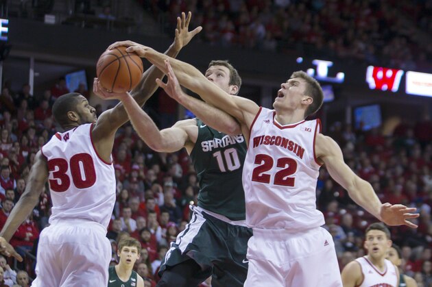Wisconsin's Ethan Happ (22) blocks a shot by Michigan State's Matt Costello (10) during the first half of an NCAA college basketball game Sunday, Jan. 17, 2016, in Madison, Wis. At left is Wisconsin's Vitto Brown (30). (AP Photo/Andy Manis)