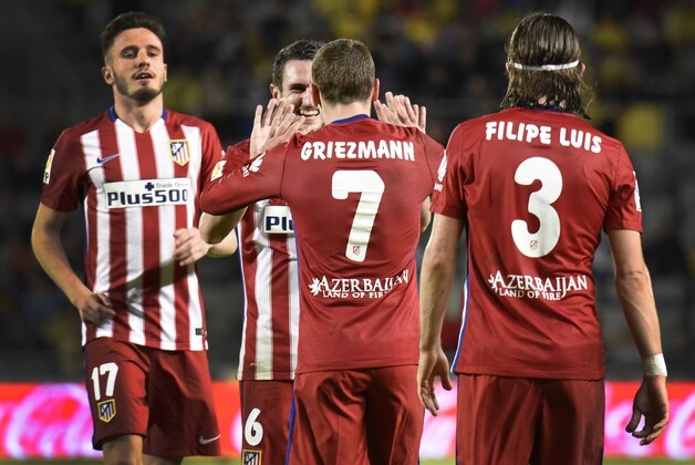 Atletico Madrid's French forward Antoine Griezmann (7) celebrates with teammates after scoring during the Spanish league football match UD Las Palmas vs Club Atletico de Madrid at the Gran Canaria stadium in Las Palmas de Gran Canaria on January 17, 2016.   AFP PHOTO/ DESIREE MARTIN / AFP / DESIREE MARTIN        (Photo credit should read DESIREE MARTIN/AFP/Getty Images)