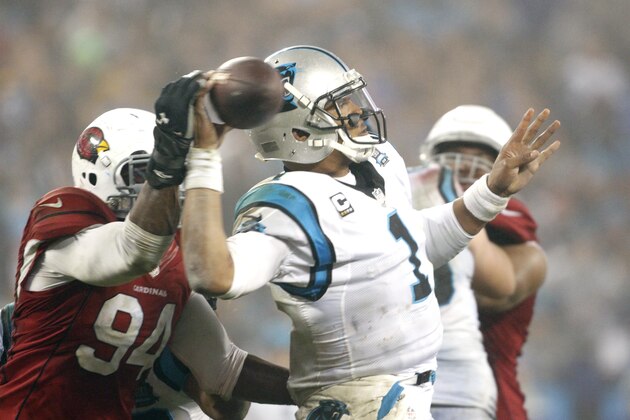 Carolina Panthers' Cam Newton (1) has his pass deflected by Arizona Cardinals' Sam Acho (94) during the second half of an NFL wild card playoff football game in Charlotte, N.C., Saturday, Jan. 3, 2015. The Panthers won 27-16. (AP Photo/Bob Leverone)
