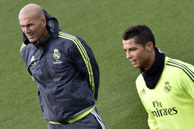 Real Madrid's new French coach Zinedine Zidane (L) and Real Madrid's Portuguese forward Cristiano Ronaldo take part in a training session at the Valdebebas training ground in Madrid on January 8, 2016.   AFP PHOTO / GERARD JULIEN / AFP / GERARD JULIEN        (Photo credit should read GERARD JULIEN/AFP/Getty Images)