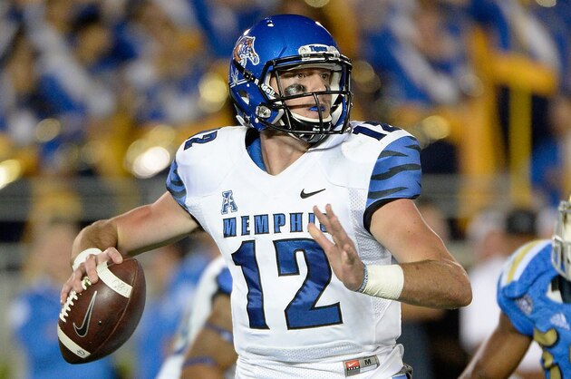PASADENA, CA - SEPTEMBER 06:  Paxton Lynch #12 of the Memphis Tigers throws as he is rushed by Deon Hollins #58 of the UCLA Bruins at Rose Bowl on September 6, 2014 in Pasadena, California.  (Photo by Harry How/Getty Images)