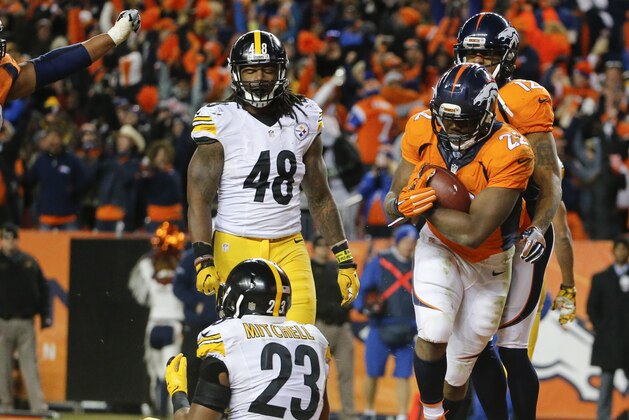 Denver Broncos running back C.J. Anderson (22), right, celebrates after scoring during the second half in an NFL football divisional playoff game against the Pittsburgh Steelers, Sunday, Jan. 17, 2016, in Denver. (AP Photo/Jack Dempsey)