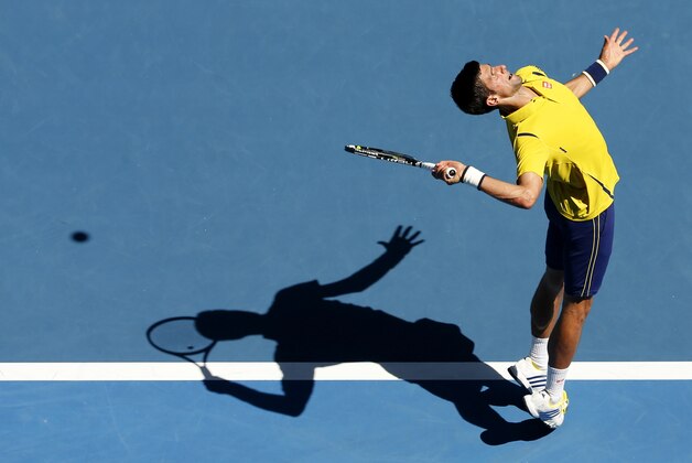 Novak Djokovic of Serbia serves to Chung Hyeon of South Korea during their first round match at the Australian Open tennis championships in Melbourne, Australia, Monday, Jan. 18, 2016.(AP Photo/Vincent Thian)