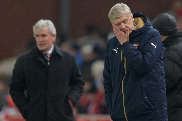 Arsenal's French manager Arsene Wenger (R) and Stoke City's Welsh manager Mark Hughes stand by a pile of snow as they watch their players during the English Premier League football match between Stoke City and Arsenal at the Britannia Stadium in Stoke-on-Trent, central England on January 17, 2016. AFP PHOTO / OLI SCARFF

RESTRICTED TO EDITORIAL USE. No use with unauthorized audio, video, data, fixture lists, club/league logos or 'live' services. Online in-match use limited to 75 images, no video emulation. No use in betting, games or single club/league/player publications.. / AFP / OLI SCARFF        (Photo credit should read OLI SCARFF/AFP/Getty Images)