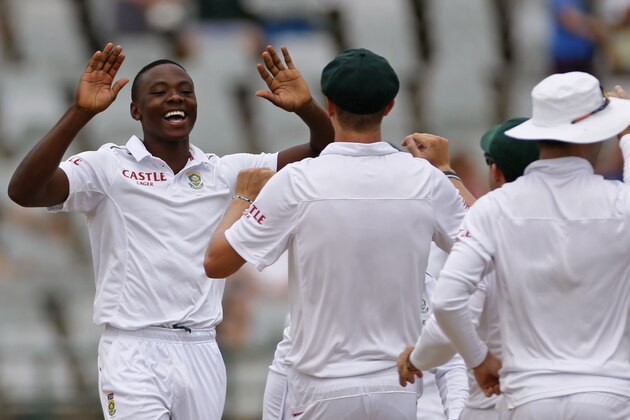 South Africa  Kagiso Rabada, left, reacts with team members after taking the wicket of  England's Alastair Cook during their second test game against  England in Cape Town, South Africa, Wednesday, Jan. 6, 2016.  (AP Photo/Schalk van Zuydam)