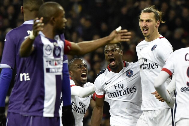 Paris Saint-Germain's Swedish forward Zlatan Ibrahimovic (R) celebrates with teammate Serge Aurier (C) after scoring a goal during the French L1 football match Toulouse vs Paris Saint-Germain  on January 16, 2016 at the Municipal stadium in Toulouse.  AFP PHOTO/ PASCAL PAVANI / AFP / PASCAL PAVANI        (Photo credit should read PASCAL PAVANI/AFP/Getty Images)