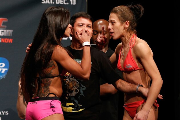 PHOENIX, AZ - DECEMBER 12:  (L-R) Opponents Claudia Gadelha of Brazil and Joanna Jedrzejczyk of Poland face off during the UFC Fight Night weigh-in event at the Phoenix Convention Center on December 12, 2014 in Phoenix, Arizona. (Photo by Josh Hedges/Zuffa LLC/Zuffa LLC via Getty Images)