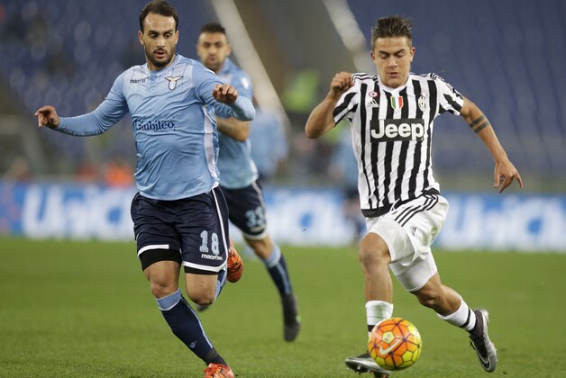 Juventus' Paulo Dybala runs with ball next to Lazio’s Santiago Juan Gentiletti during a Serie A soccer match between Lazio and Juventus, at Rome's Olympic Stadium, Friday, Dec. 4, 2015. (AP Photo/Andrew Medichini)