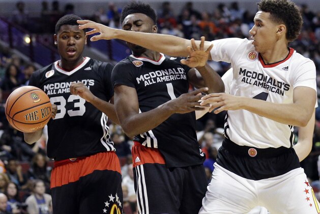 West center Chase Jeter, right, of Bishop Gorman in Las Vegas, battles for a rebound against East small forward Jaylen Brown, of Wheeler in Marietta, Ga., as center Diamond Stone (33), of Dominican in Whitefish Bay, Wis., watches during the second half of the McDonald's All-American boys basketball game in Chicago on Wednesday, April 1, 2015. The East won 111-91. (AP Photo/Nam Y. Huh)