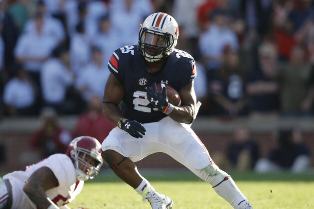 Auburn running back Peyton Barber (25) runs the ball against Alabama defensive lineman D.J. Pettway (57) during an NCAA college football game, Saturday, Nov. 28, 2015, in Auburn, Ala. (AP Photo/Gerald Herbert)