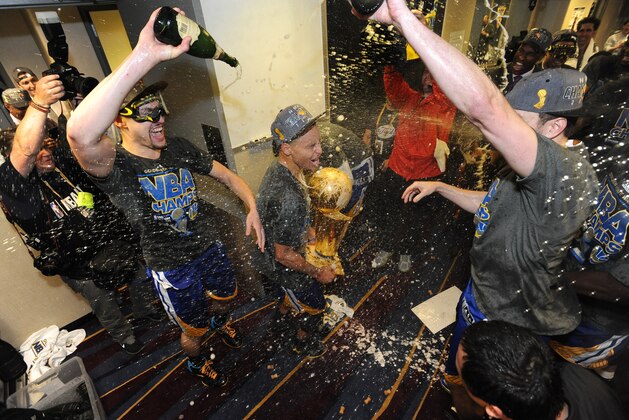 CLEVELAND, OH - JUNE 16: Klay Thompson #11 and Stephen Curry #30 of the Golden State Warriors celebrate winning the Larry O'Brein Trophy after Game Six of the 2015 NBA Finals against the Cleveland Cavaliers at the Quicken Loans Arena on June 16, 2015 in Cleveland, Ohio. NOTE TO USER: User expressly acknowledges and agrees that, by downloading and/or using this Photograph, user is consenting to the terms and conditions of the Getty Images License Agreement. Mandatory Copyright Notice: Copyright 2015 NBAE (Photo by Noah Graham/NBAE via Getty Images)