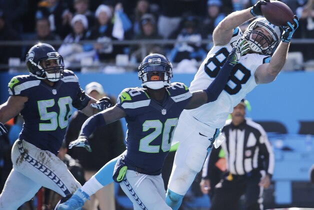 Carolina Panthers tight end Greg Olsen (88) makes a touchdown catch against Seattle Seahawks cornerback Jeremy Lane (20) during the first half of an NFL divisional playoff football game, Sunday, Jan. 17, 2016, in Charlotte, N.C. (AP Photo/Chuck Burton)
