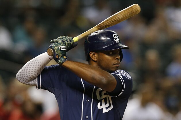 San Diego Padres left fielder Justin Upton (10) fields the ball against the Arizona Diamondbacks in the sixth inning during a baseball game, Tuesday, Sept. 15, 2015, in Phoenix. (AP Photo/Rick Scuteri)