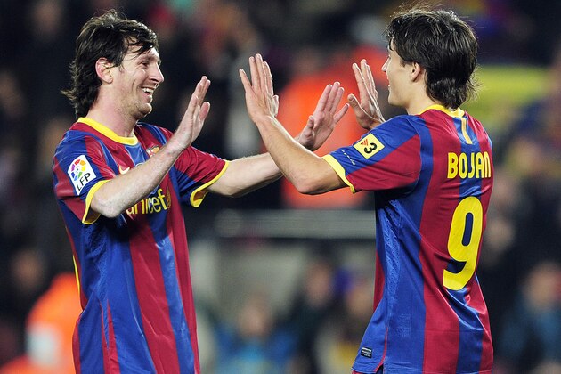 Barcelona's forward Bojan Krkic (R) celebrates with his team-mate Barcelona's Argentinian forward Lionel Messi (L) after scoring against Real Sociedad during their Spanish league football match at the Camp Nou stadium in Barcelona on December 12, 2010.  FC Barcelona won 5-0.   AFP PHOTO/ JOSEP LAGO (Photo credit should read JOSEP LAGO/AFP/Getty Images)