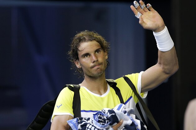 Rafael Nadal of Spain waves to the crowd as he leaves Rod Laver Arena after losing to compatriot Fernando Verdasco in their first round match at the Australian Open tennis championships in Melbourne, Australia, Tuesday, Jan. 19, 2016.(AP Photo/Aaron Favila)