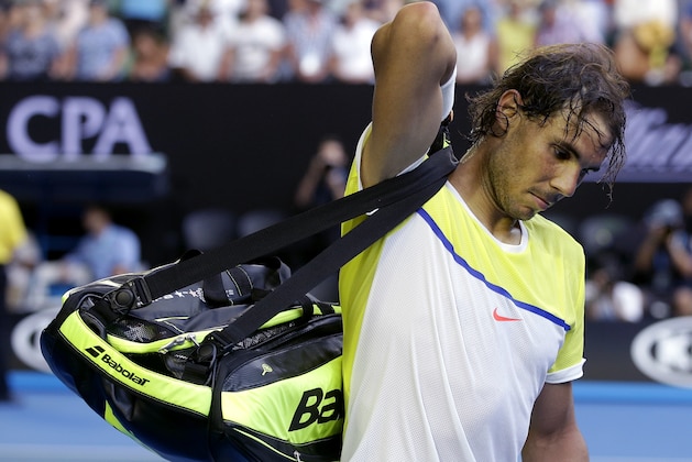 Rafael Nadal of Spain packs his bags as he leaves Rod Laver Arena following his loss to compatriot Fernando Verdasco in their first round match at the Australian Open tennis championships in Melbourne, Australia, Tuesday, Jan. 19, 2016.(AP Photo/Mark Baker)