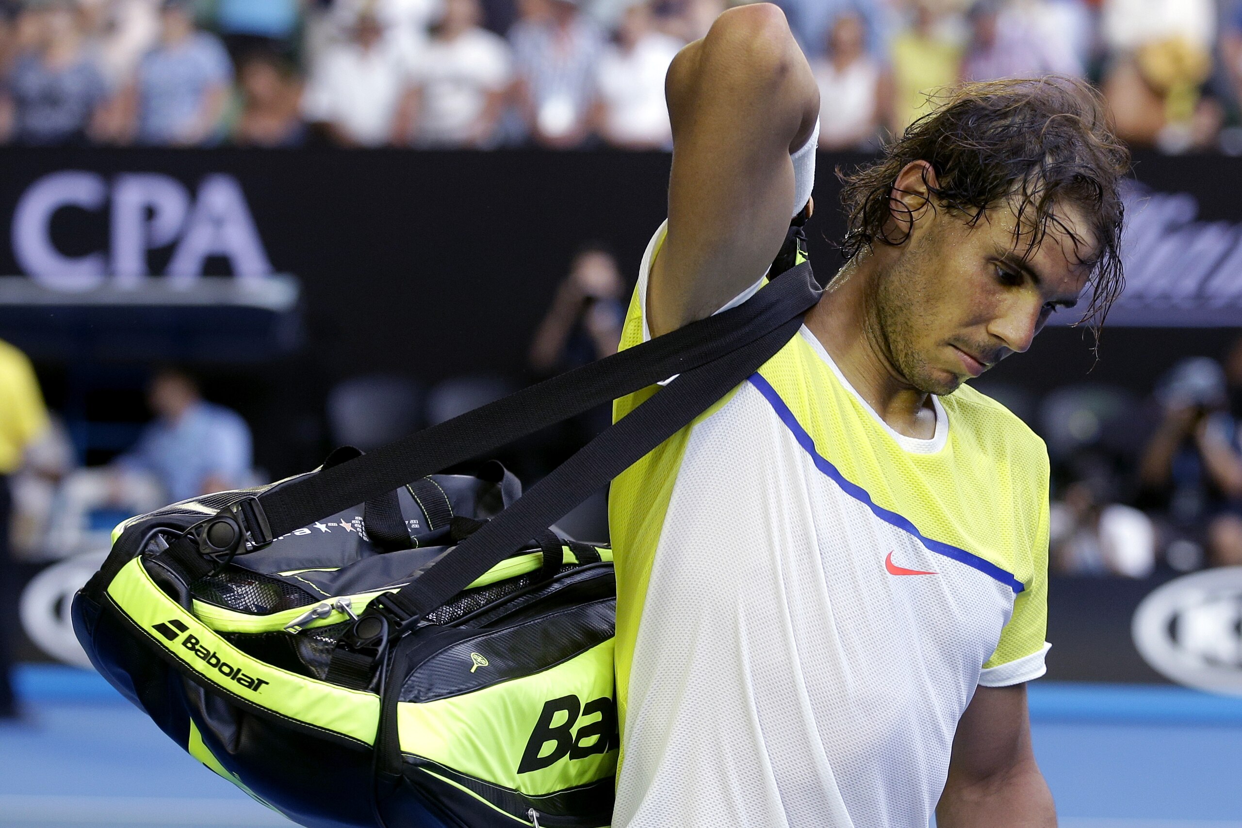 Rafael Nadal of Spain packs his bags as he leaves Rod Laver Arena following his loss to compatriot Fernando Verdasco in their first round match at the Australian Open tennis championships in Melbourne, Australia, Tuesday, Jan. 19, 2016.(AP Photo/Mark Baker)