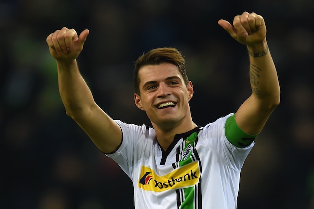 Moenchengladbach's Swiss midfielder Granit Xhaka celebrates after the German first division Bundesliga football match Moenchengladbach vs Bayern Munich in Moenchengladbach on December 5, 2015.  
 / AFP / PATRIK STOLLARZ        (Photo credit should read PATRIK STOLLARZ/AFP/Getty Images)
