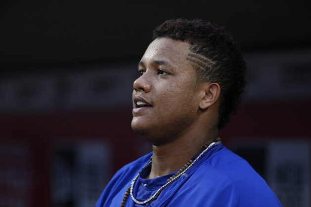 Chicago Cubs shortstop Starlin Castro stands in the dugout before a baseball game against the Cincinnati Reds, Wednesday, Sept. 30, 2015, in Cincinnati. The Cubs won 10-3. (AP Photo/John Minchillo)