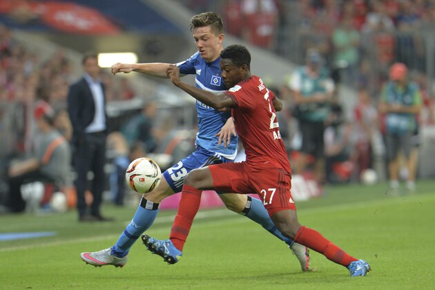 Hamburg’s Michael Gregoritsch, left, and Bayern's David Alaba challenge for the ball during the German Bundesliga soccer match between FC Bayern Munich and Hamburger SV in Munich, southern Germany, Friday, Aug. 14, 2015. (AP Photo/Kerstin Joensson)