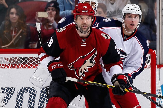 GLENDALE, AZ - DECEMBER 17:  John Scott #28 of the Arizona Coyotes sets up in front of Ryan Murray #27 of the Columbus Blue Jackets during the NHL game at Gila River Arena on December 17, 2015 in Glendale, Arizona.  The Blue Jackets defeated the Coyotes 7-5.  (Photo by Christian Petersen/Getty Images)