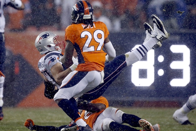 New England Patriots tight end Rob Gronkowski (87) is up-ended by Denver Broncos free safety Darian Stewart as free safety Bradley Roby (29) looks on during the first half of an NFL football game, Sunday, Nov. 29, 2015, in Denver. (AP Photo/Joe Mahoney)