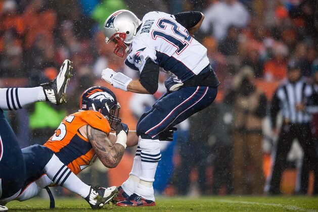 DENVER, CO - NOVEMBER 29: Quarterback Tom Brady #12 of the New England Patriots is sacked by defensive end Derek Wolfe #95 of the Denver Broncos in the first quarter at Sports Authority Field at Mile High on November 29, 2015 in Denver, Colorado. (Photo by Dustin Bradford/Getty Images)
