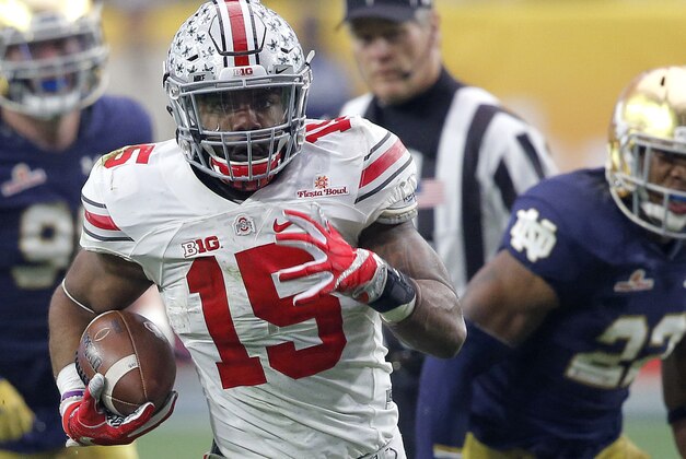 Ohio State running back Ezekiel Elliott (15) breaks free for a touchdown run against Notre Dame during the second half of the Fiesta Bowl NCAA College football game, Friday, Jan. 1, 2016, in Glendale, Ariz.  (AP Photo/Ross D. Franklin)