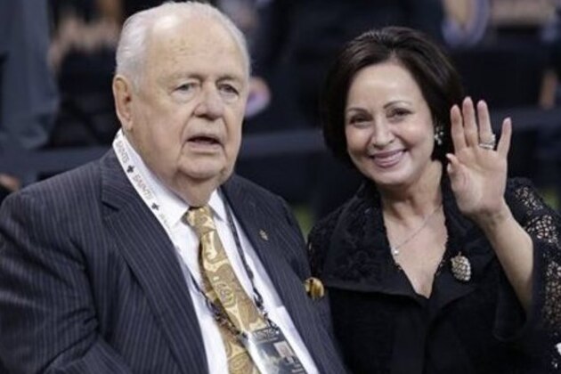 FILE - In this Oct. 26, 2014, file photo, New Orleans Saints owner Tom Benson sits on the sideline with his wife Gayle Benson before an NFL football game against the Green Bay Packers in New Orleans. Tom Benson, who owns the Saints and NBA's Pelicans, asserted in a statement released Thursday, Jan. 22, 2015,  that removing his daughter and grandchildren from the operation of his sports franchises _ and inserting his wife of 10 years in their place _ will ensure the clubs’ long-term stability and future in New Orleans. (AP Photo/Bill Haber, File)