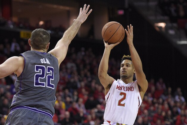 Maryland guard Melo Trimble (2) puts up a shot against Northwestern center Alex Olah (22) during the second half of an NCAA college basketball game, Tuesday, Jan. 19, 2016, in College Park, Md. Maryland won 62-56 in overtime. (AP Photo/Nick Wass)